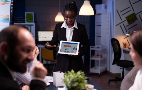 Entrepreneur woman with dark skin overworking in company office meeting room